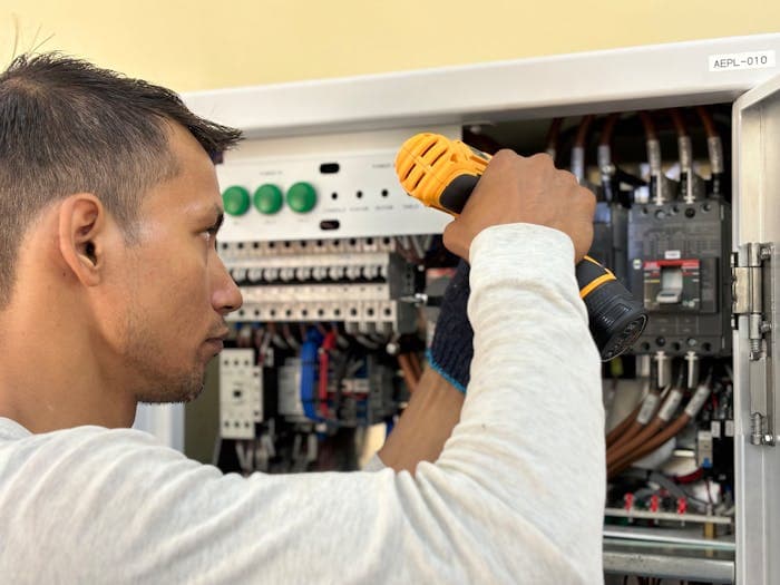 Electrician working on an electrical panel